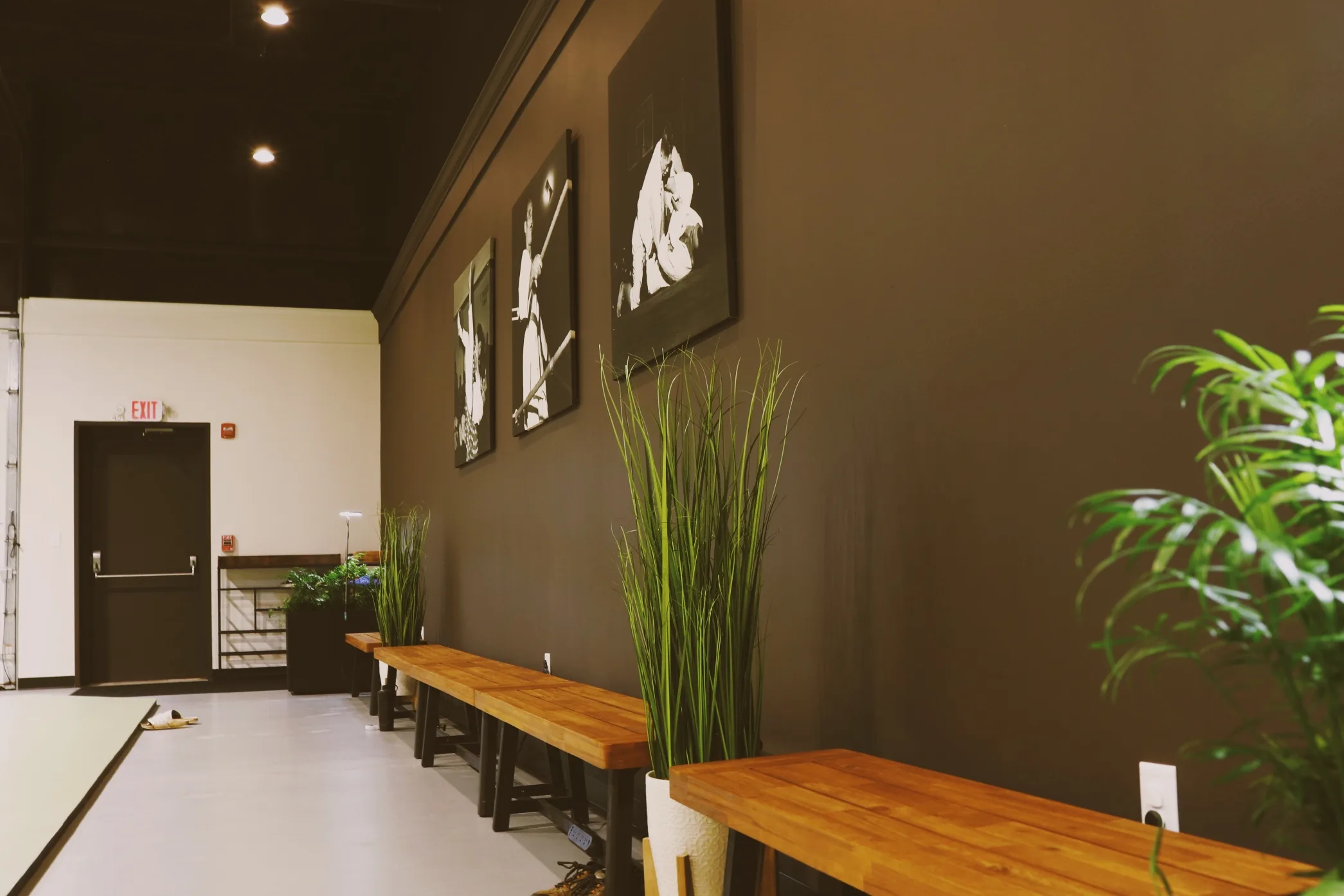 A hallway inside the academy lined with historic photographs of jiu-jitsu founders.