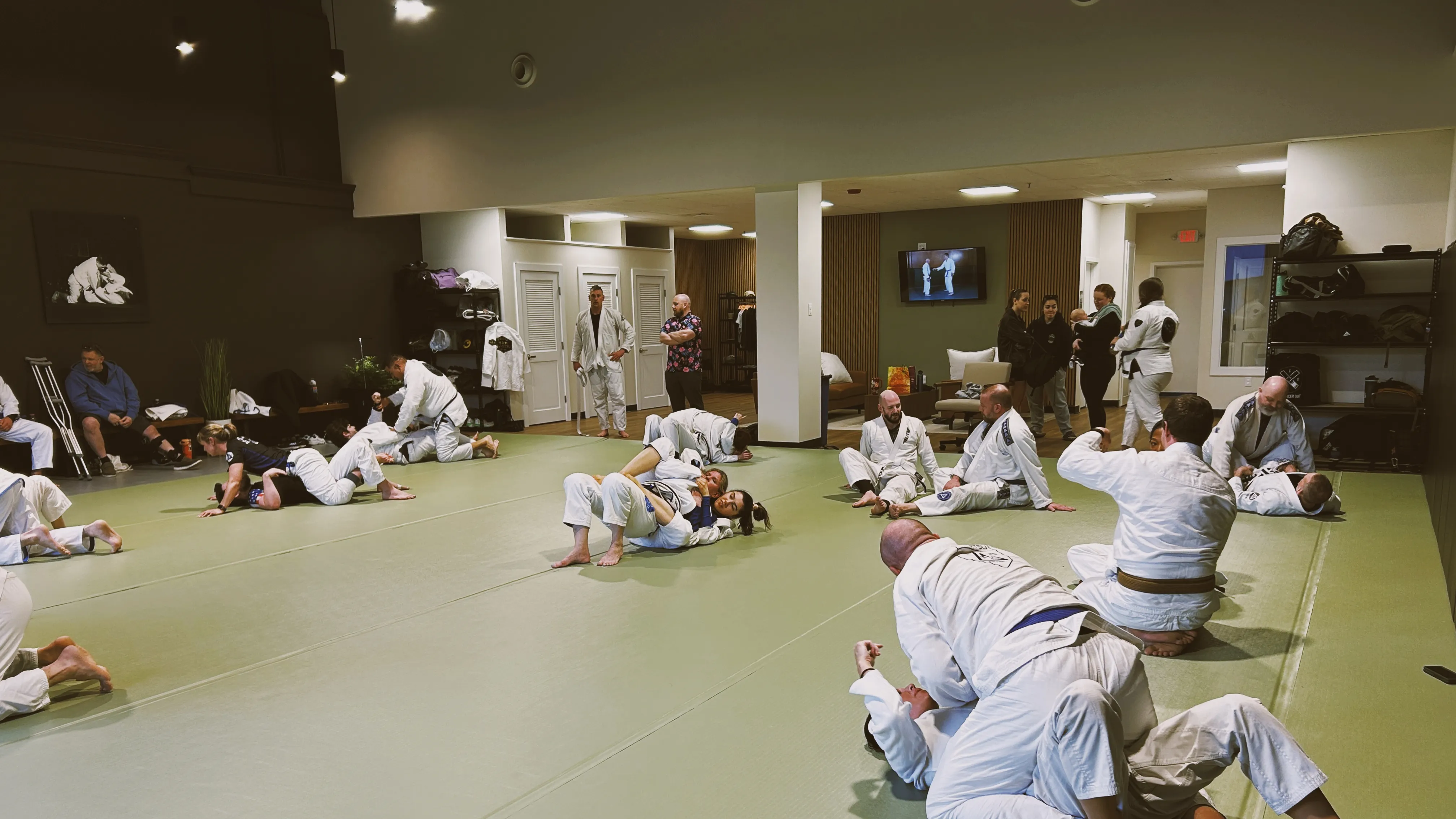 Students in open training, practicing positions on the mat.